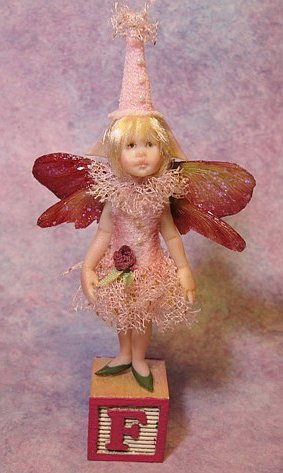 Polymer clay doll artist creating 1:12 scale dollhouse miniature dolls with tiny wings for fairy or fae display by CDHM Artisan Carol McBride of The Sweetest Tiny Things