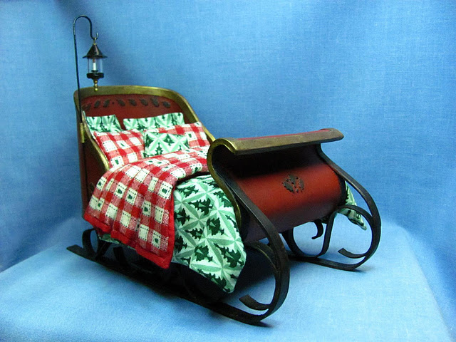 One of a kind, Christmas sleigh bed in 1:12 scale is hand made by CDHM Artisan Kris Compas of 1 Inch Minis