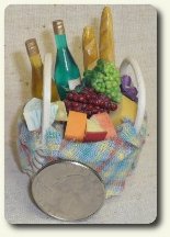 CDHM Artisan Mary Pat Bonafice created a picnic basket with wine and cheese for the 1:12 scale kitchen