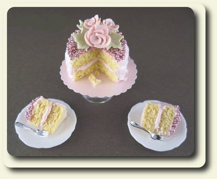 CDHM artisan Monica Cado Shellabarger creating under the business name of Bon Sucre Miniatures created this floral cake with a french accent for the dollhouse miniature collector in 1:12 scale