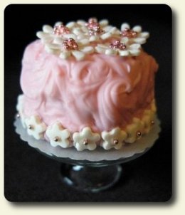 CDHM artisan Monica Cado Shellabarger creating under the business name of Bon Sucre Miniatures created this floral cake with a french accent for the dollhouse miniature collector in 1:12 scale