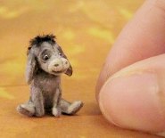 CDHM artisan Aleah Klay sculpts from polymer clay, creating 1:12 scale furred animals