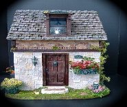 CDHM artisan Tracy Topps of Minis On The Edge creates dollhouse scale wooden dollhouses in paperclay