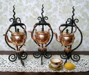 CDHM forum member, catherine (maryheartline3) is an artist and a metalsmith creating teapots and burners from brass. These are gold plated with the stands out of sterling silver and oxidized them black to appear to be wrought iron. The pots were fabricated from sheet and the burners were made from telescoping brass tubes and sheet stock. The knobs and handles are ebony.