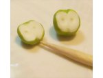 Marking the apple seeds areas of the miniature dolls apples