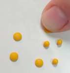 Creating the miniature egg yolks by flattening the polymer clay