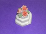 Inserting the roses onto the miniature wedding cake