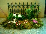 Pressing the clay flowers into the garden