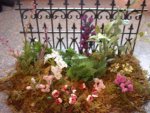 Adding last touches to the dolls house flower garden