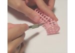 Cutting off sections of the hair roller to make dollhouse found object