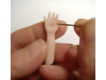 Creating line detail in the palm of the miniature dolls palm hand