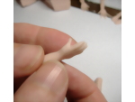 Shaping the thumb into position to create a natural look of the polymer clay hand