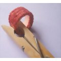 Clamping the two ends of the fabric crown together with a clothes peg or clothes pin