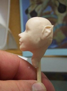 completed sculpt of a doll, fairy or fantasy head and face from polymer clay