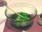 Take your chopstick and push the feathers under the colored dye water
