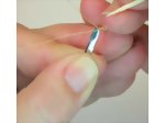 Using the tweezers to grip the end