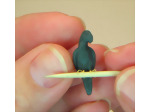 Checking for feet spacing before baking the polymer clay miniature parrot