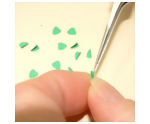 Folding the heart shaped hole punches to create the leaves