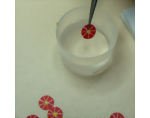 Using tweezers dip one of the hole punched circles into water container