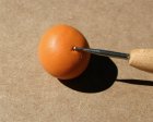 Using A Ball Stylus to Mark for the Stem and the Blossom End of the Pumpkin