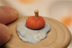 Using blue tack to hold the pumpkin in place