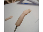 Attaching a wire to the arm of the sculpted hand so that you can insert into dolls body
